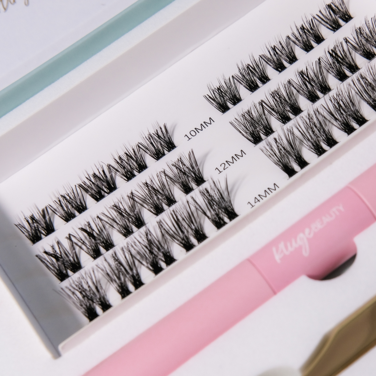 Detailansicht eines Lash-Sets mit unterschiedlichen Längen (10mm, 12mm, 14mm), präsentiert in einer eleganten weißen Box, ideal für individuelle Wimpern-Looks.