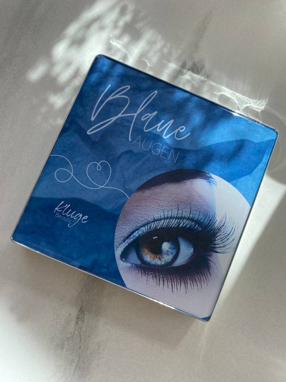 Lidschattenpalette für blaue Augen von Kluge Beauty mit einer stilvollen Verpackung und schimmernden Blau- und Naturtönen.